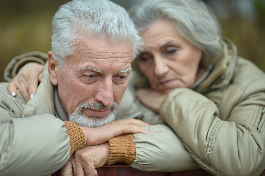 Sad senior couple in  park